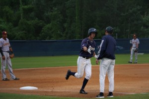 Drew Weeks high fiving after circling the bases on his home run hit. Photo by Bronwyn Knight.