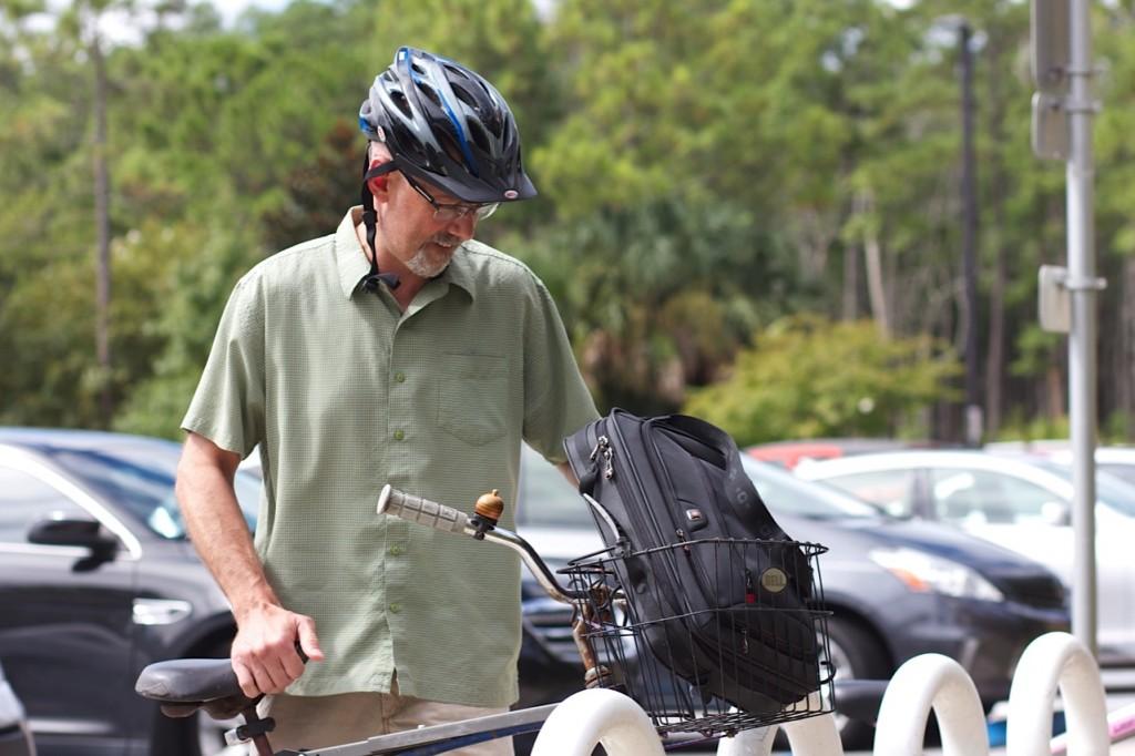 John White, Ph.D, associate professor in the Department of English Education, has to ride his bike from a far away lot.Photo by Blake Middleton