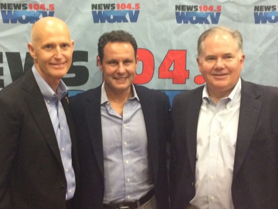 Rick Scott, Brian Kilmeade and Rush Limbaugh pose in front of WOKV news.  Photo courtesy WOKV