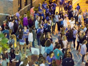 Students wait in Osprey Crossings to march across campus to show support for survivors and raise awareness about domestic violence. Photo by Michael Herrera