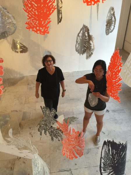 Goloborotko (left) viewing her work from above with UNF fine art student Camille Modesto.