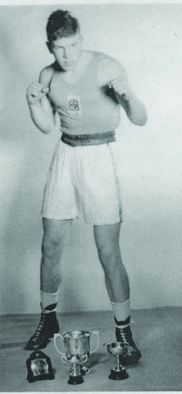 Comyns, shows off his boxing trophies in 1954.  Photo courtesy of Ken Comyns. 