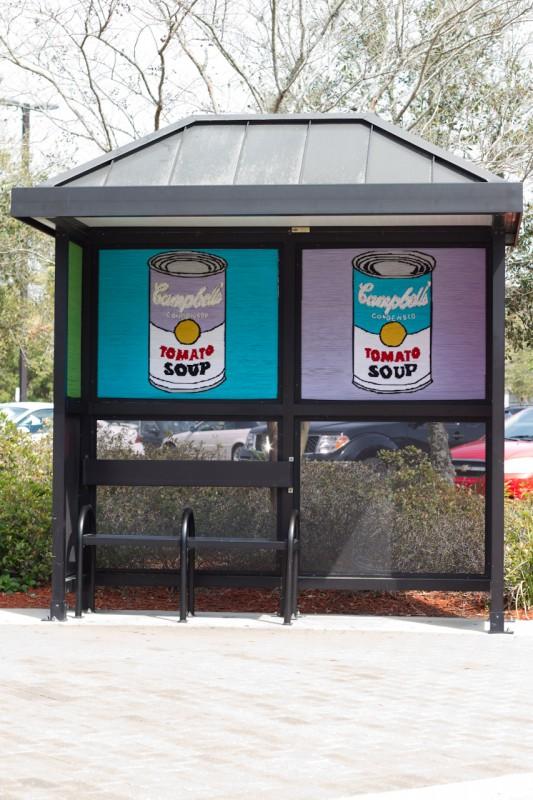 Art students recreated Andy Warhol's soup can painting on the city bus stop in front of the library.  Photo by Randy Rataj
