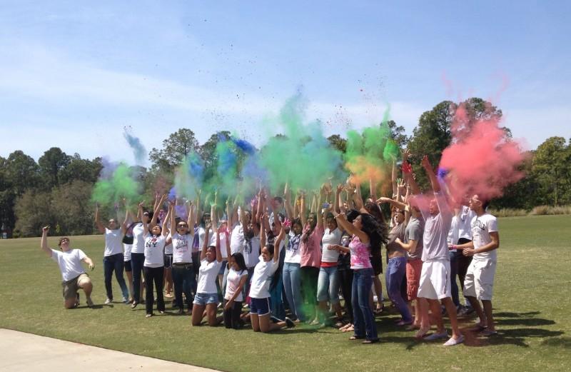 Students celebrate Holi and throw colored powder in the air. Photo by Jessica Harden