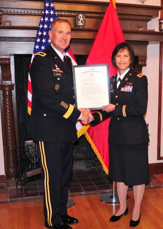 Newly-promoted Col. Leslie Caballero, right, receives her certificate of promotion from her former boss Brig. Gen. Randal Dragon, former commander of the Brigade Modernization Command at Fort Bliss, Texas, during a formal ceremony. Caballero earned her commission in 1990 through the Army ROTC program at the University of North Florida. Photo by Lt. Col. Deanna Bague
