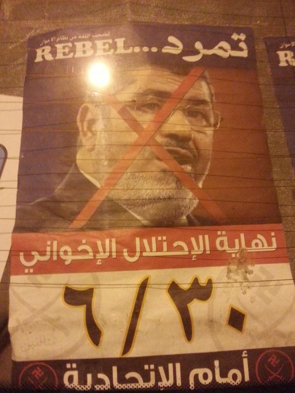 credit: Lydia Moneir Mohamed Morsi's face is crossed out on a poster that reads "The Brotherhood's Occupation Ends June 30."