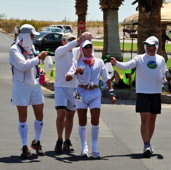 Costa's team surrounds her and sprays her down with water during the race. 