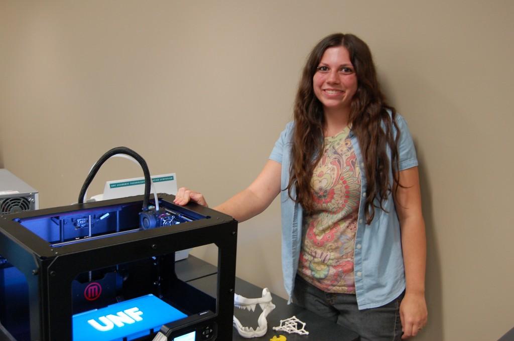 Academic Support Technician Donatella Schianomoriello stands with the MakerBot Replicator 2. Photo by Natalie Logan