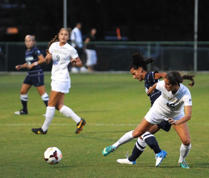Forward Carolina Lencina jostles with a JU defender during a match that featured 22 fouls. 