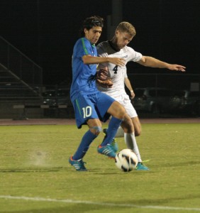 Christopher Bush battles with a FGCU defender. (Photo credit Garrett Haupt)