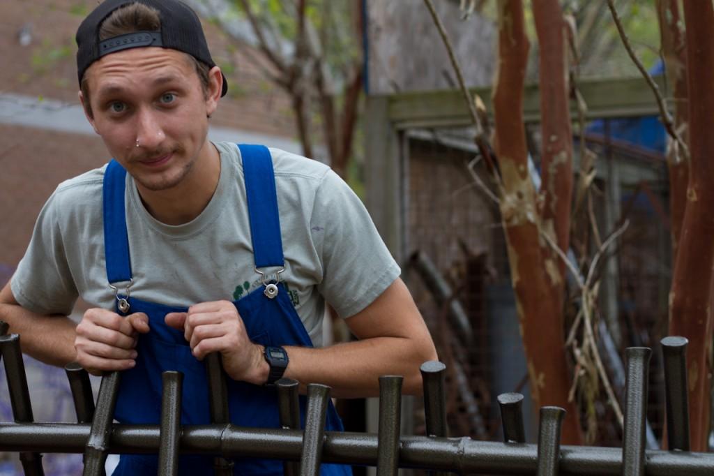 Bailey leans on the bamboo bike rack he created for UNF's campus. Photo by Randy Rataj.