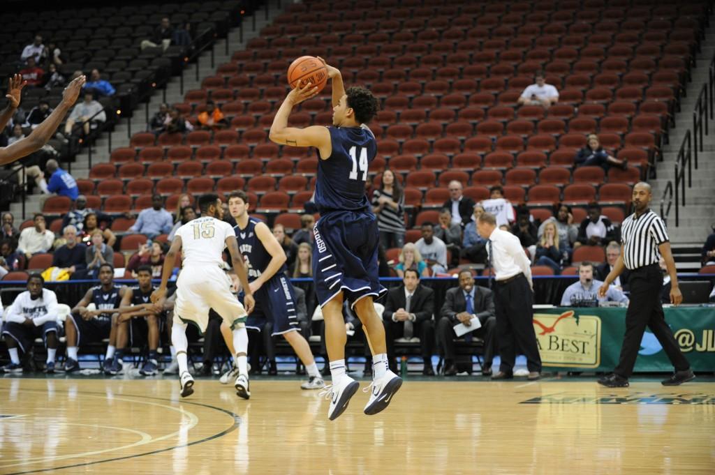 Dallas Moore looks for a three-pointer against the Dolphins. Moore scored 10 points on the night. Photo Shippee