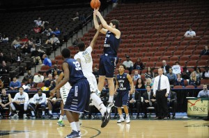 Beau Beech takes a jumpshot over JU's J.R. Holder. Beech added 21 points to the win. Photo by John Shippee.