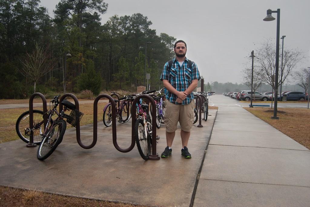 Matthew Adkins a business administration major stands where his bike was once stolen at UNF Fountains. Photo by Randy Rataj.  