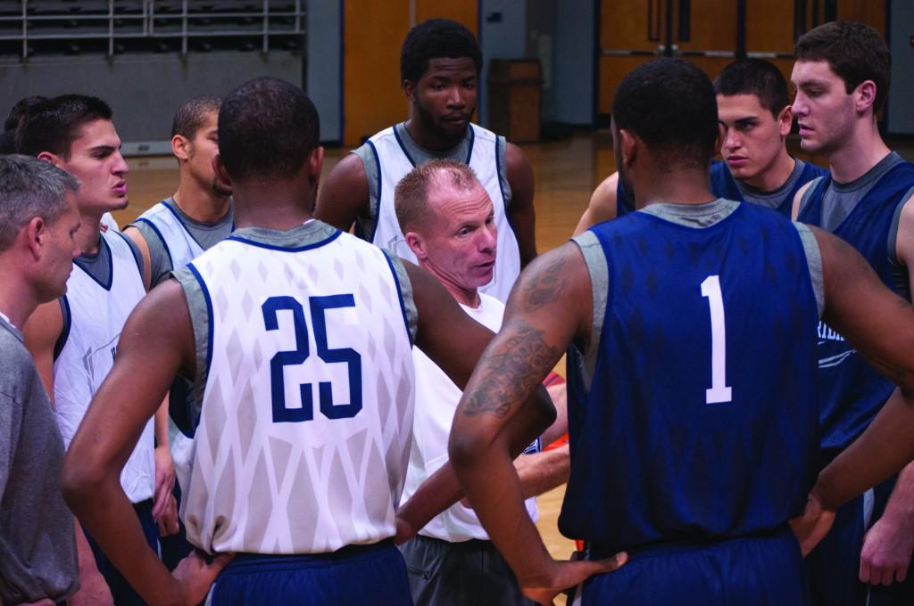 The UNF men's basketball team gathers around coach Matthew Driscoll during practice. Photo by Travis Gibson