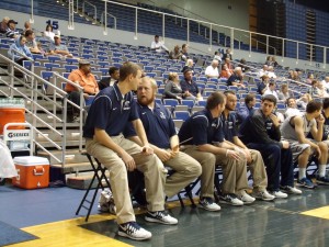 Zack Freesman sits with his other team managers on the sideline. Photo by Sarah Ricevuto. 