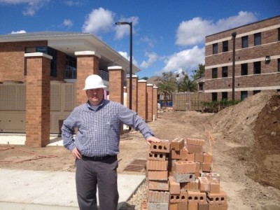 Bob Boyle, director of Housing and Resident Life, stands in front of the construction.  Photo by Brian Blackwell