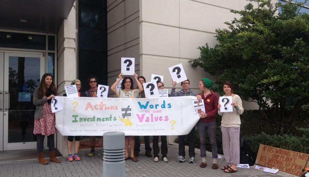 Divest UNF's protest was passive. They stood and gave information sheets to Foundation board members as they entered. Photo by Saphara Harrell