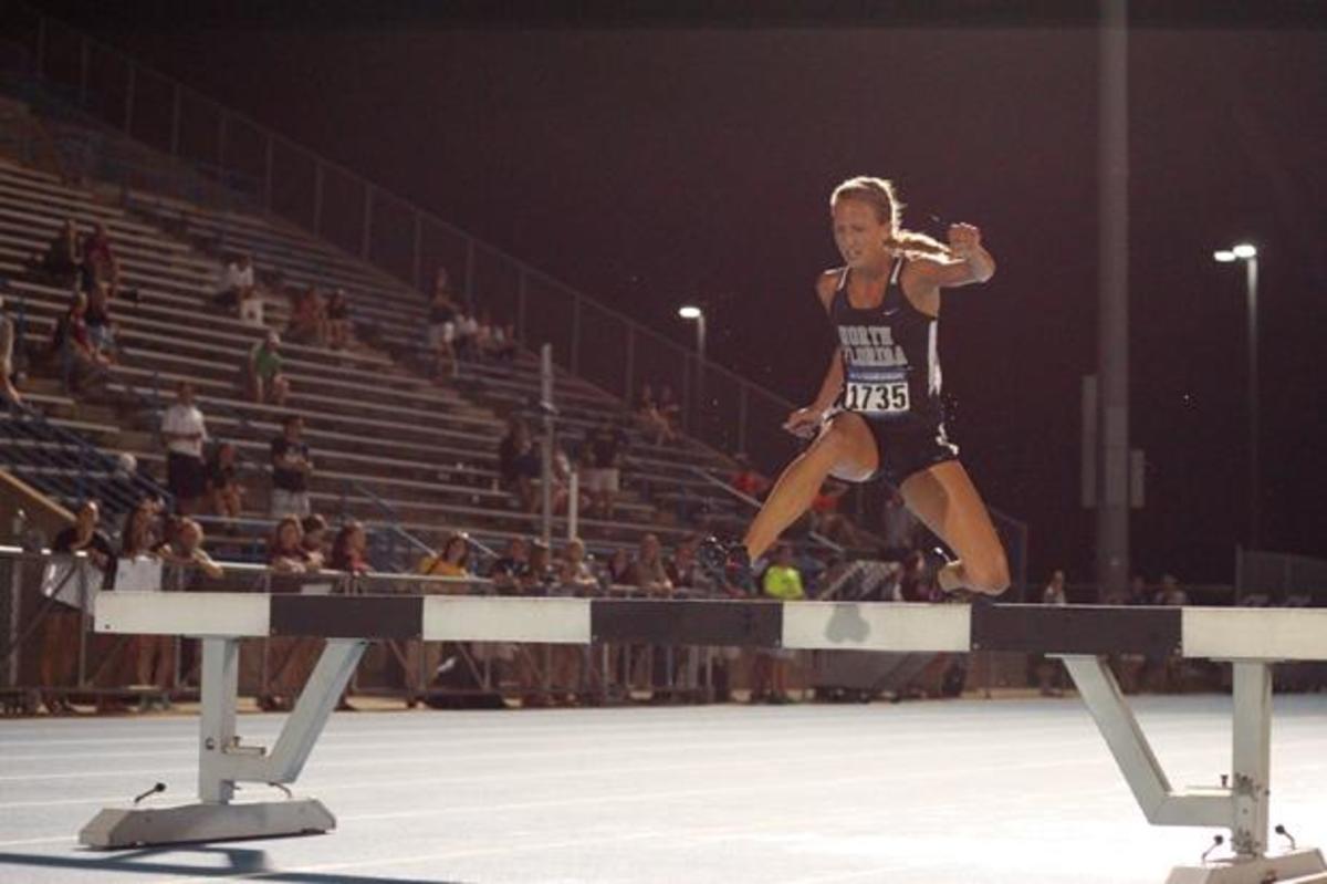UNF’s Elle Baker jumps over one of the four hurdles during the steeplechase race. Photo by Joshua Brangenberg. 