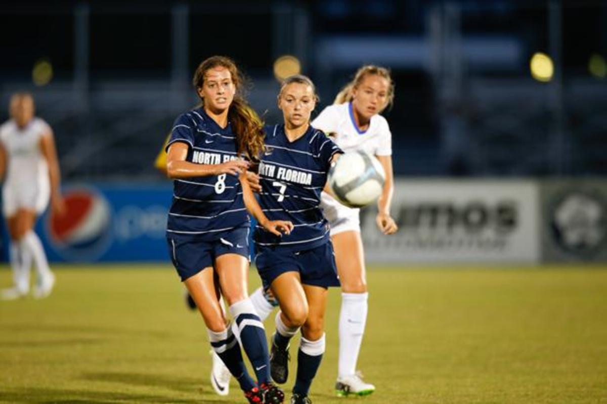 Ashley Carmean (left) and Mikki Olson (right) dash after the ball.  Photo by Camille Shaw