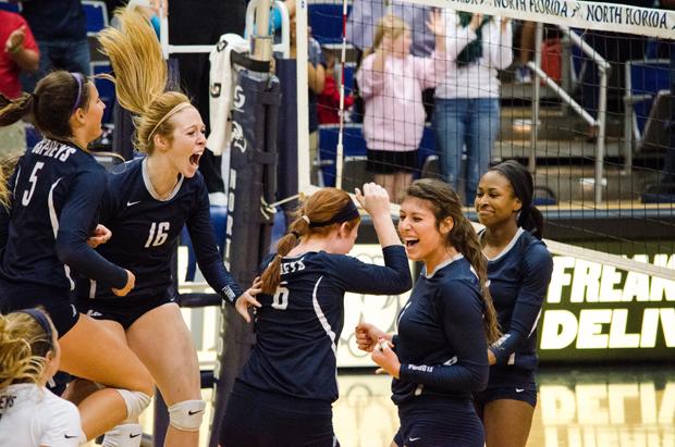 Courtney Miller (5), Tessa Alyman (16), Abby Fesl (6) Carina Hoff (1) and Erin Edwards (2) celebrate after beating JU on Oct. 24. Photo by Robert Curtis