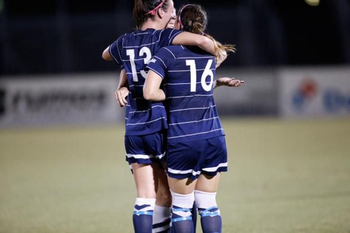  UNF midfielder Jill Holdsworth and fellow teammates celebrate after her goal. Photo by Joshua Brangenberg