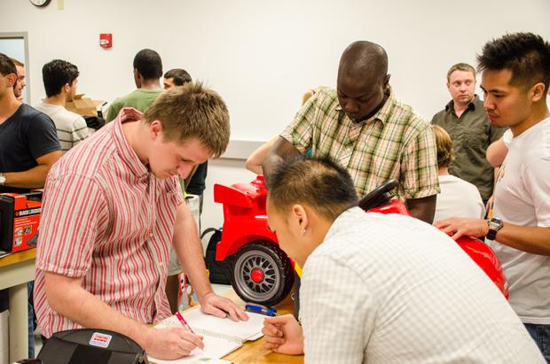 Engineering students redesign ride-on toy cars to meet the needs of children with physical disabilities. Photo by Robert Curtis