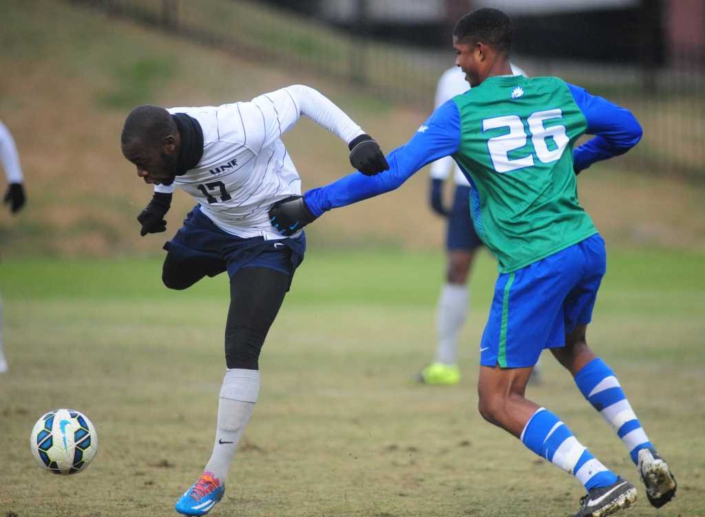 UNF’s Teddy Mulamba (17) heading the ball down, keeping it from FGCU’s Kamar Marriott. Photo courtesy ASunPhotos.com