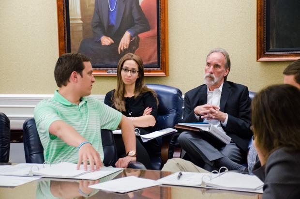 Director of Analytics and Research Christopher Brady speaks to Associate VP of Student Affairs Everett Malcolm at the Student Fee Assessment Committee meeting Dec. 2.  Photo by Robert Curtis