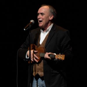 Opening comedian John Bowman plays a tune on his ukulele. Photo by Tyler Van Voorthulsjen 