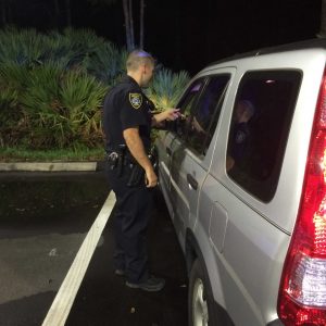 Officer Morgan talks to a driver who was speeding on UNF Drive.   Photo by Patrick Lloyd 