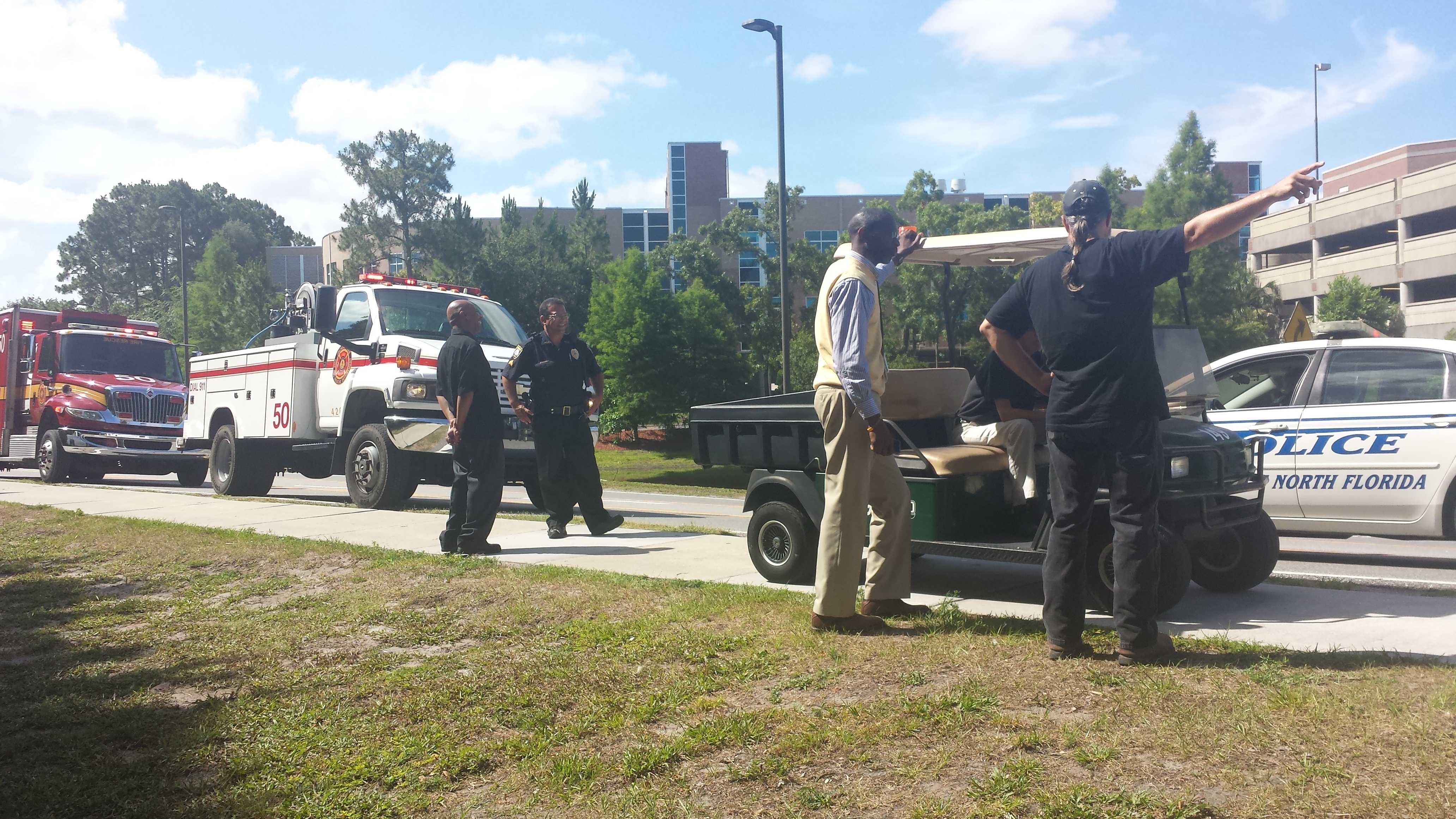 Officers and maintenance workers observe the scene of the crash.Photo by Alex Wilson