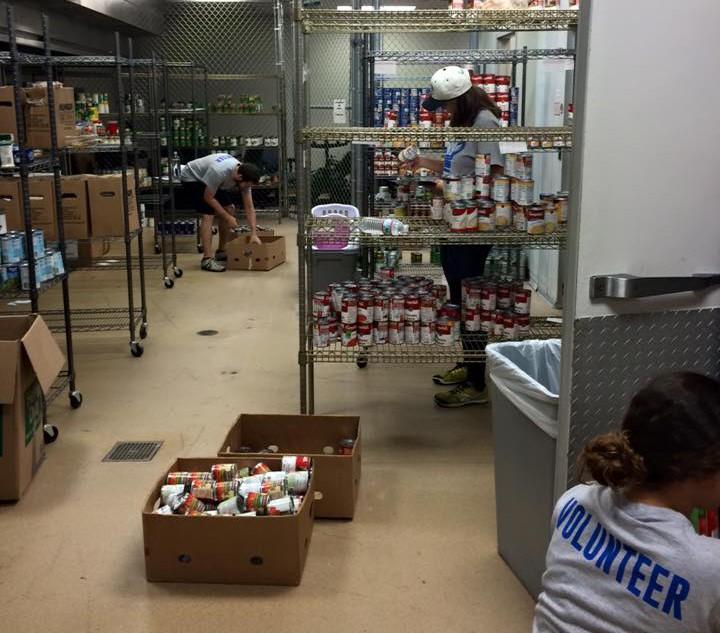 Volunteers sort through donations to stock the pantry shelves.Photo courtesy Facebook