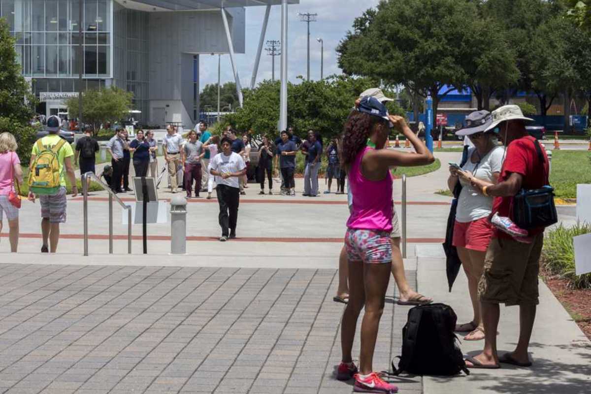 Evacuated students and parents look on while waiting for officals to call an all clear.Michael Herrera