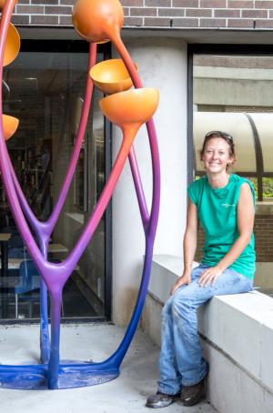 5.Mary Ratcliff, sculpture junior, sits next to her piece “Connect V” on the right side of the reading alcove.  Photo by Michael Herrera 