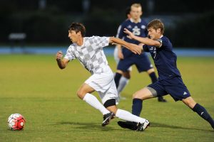 UNF forward Alex Morrell slips past a GS defender. Photo courtesy of UNF Athletics.