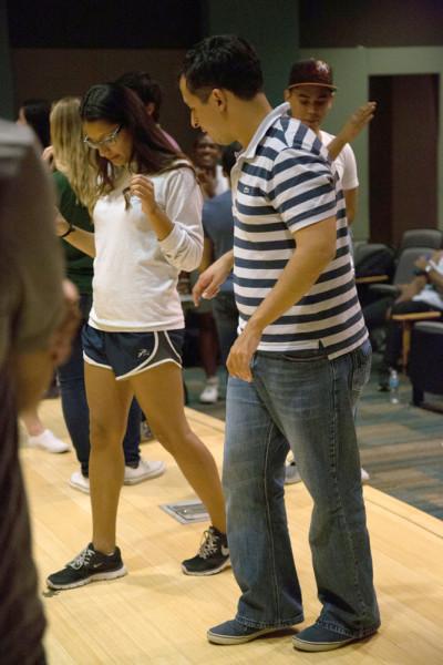 Andres Espinosa, salsa instructor at Tumbao Dance Studios on Baymeadows Road, works with a student to help her grasp the steps to a dance. Photo by Courtney Stringfellow