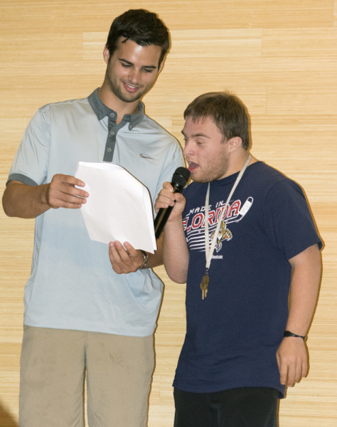 Sophmore Randy Kersh giving a speech and getting support from his buddy, junior Curtis Kroll. Photo by Kristen Smith