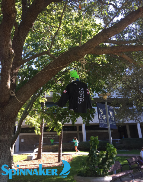 The torn jacket from a multicultural fraternity (Sigma Beta Rho) was found hung by a tree near the Green this morning.  Photo by Blake Allen