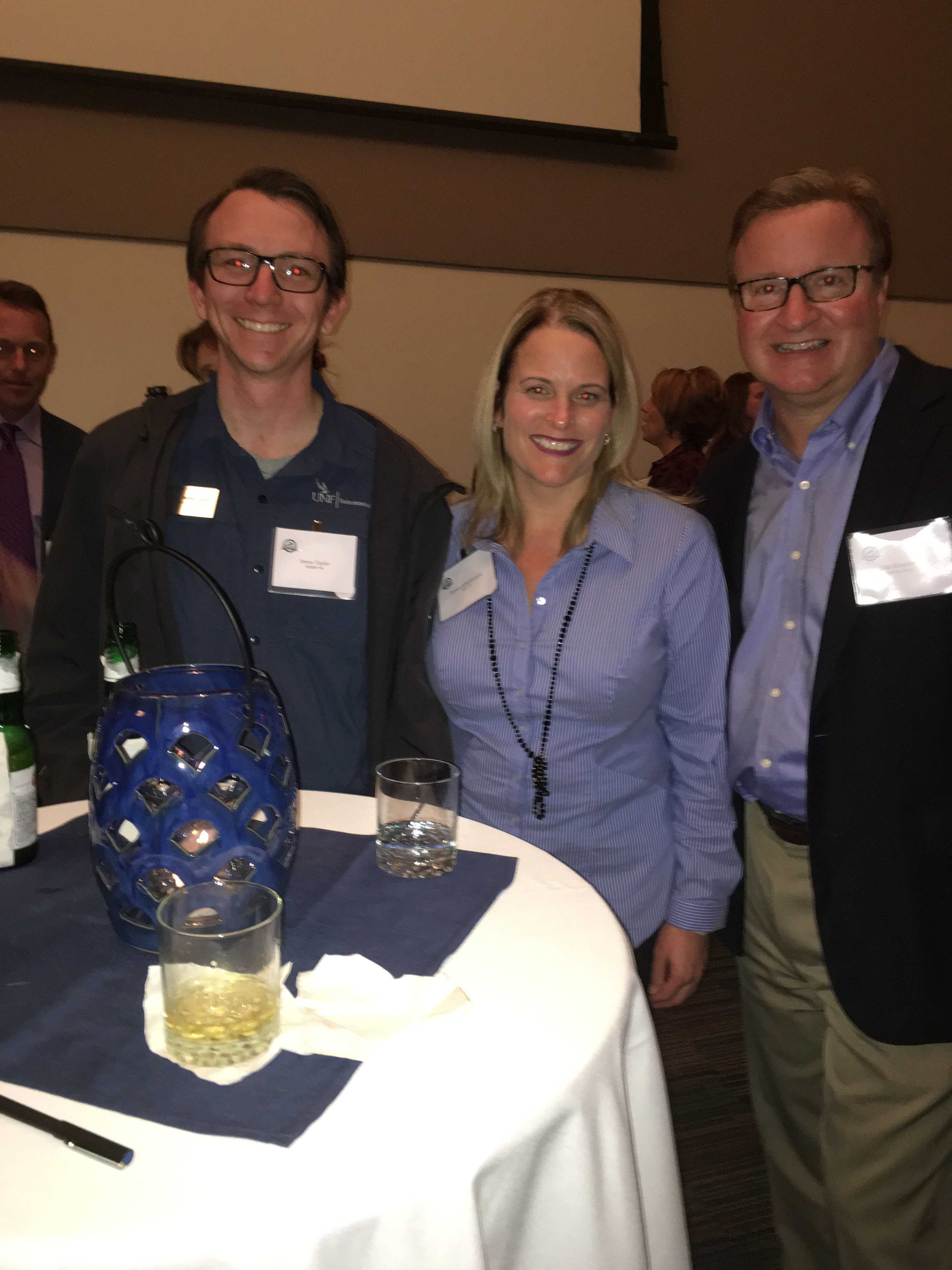UNF Alumni James Taylor, Jessica Klopfstein and John Klopfstein enjoy the cocktail reception before the ceremony. Photo by Jordan Bebout
