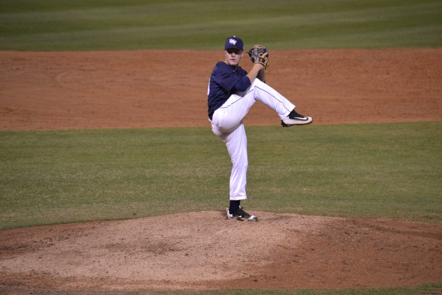 Freshman Austin Drury winds up to deliver a pitch.

Photo by Emily Woodbury