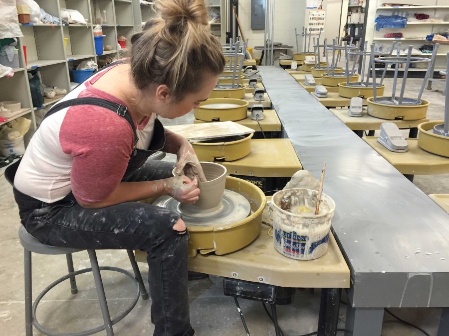 Tanner works on a piece in the ceramics studio on campus.
Photo by Tiffany Salameh