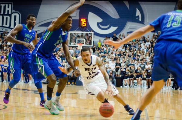 Moore dodging two Eagle defensemen in a drive to the basket Photo by Connor Spielmaker 