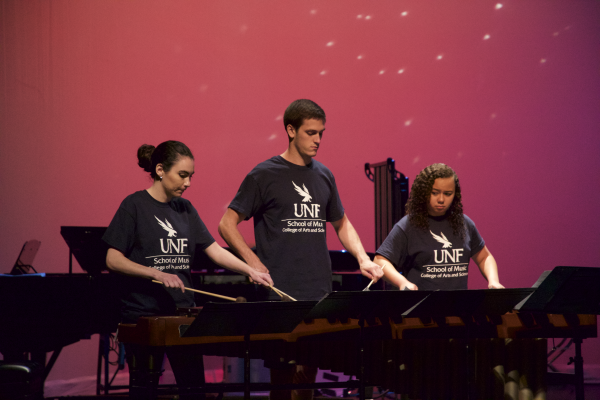 Three percussionists open rehearsal with their first piece for the concert. Photo by Rachel Cazares. 