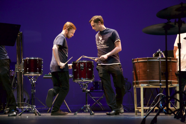 The percussionists had a routine while they played, reaching over and playing the drum next to them and rotating around one together. Photo by Rachel Cazares. 