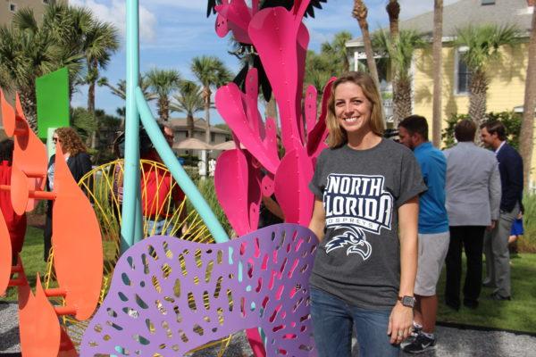 Gillian Harper stands by “Ongoing Life.” Harper is a senior sculptor student and plans to attend graduate school. Photo by Brittany Moore.