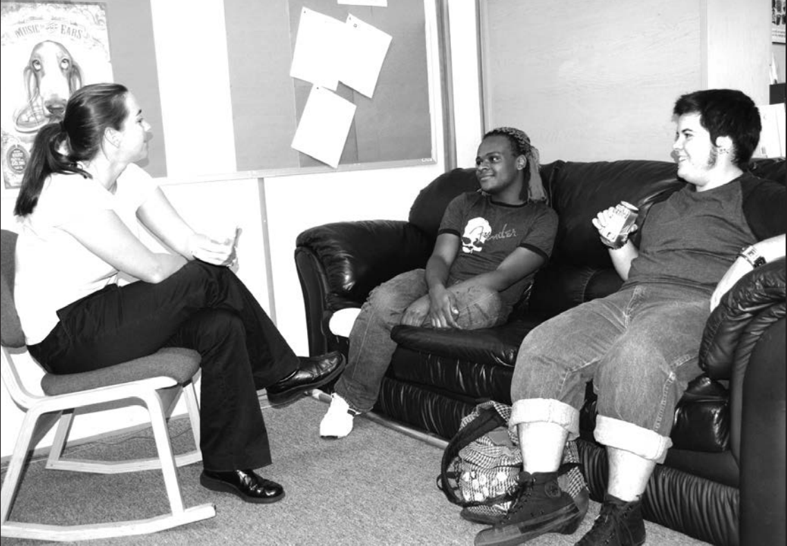 Emily Rokosch, LGBT education coordinator, chats with students Marcus Google and Dean Bonilla at the office on campus. Photo from UNF Spinnaker Print Archives