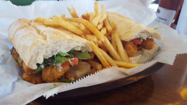 The shrimp po' boy is stuffed with crunchy fried shrimp and juicy tomatoes. Photo by Courtney Stringfellow 