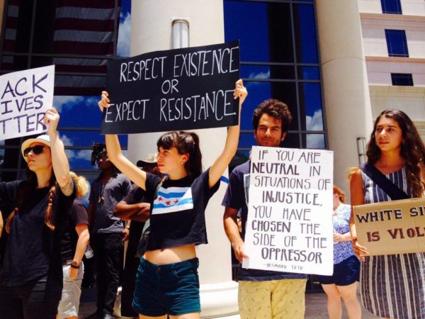 Richard Miele (right) stands with other UNF students at the rally.