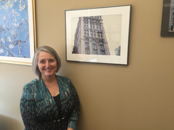 Knipe standing next to the photo in her office. Photo by Nick Blank